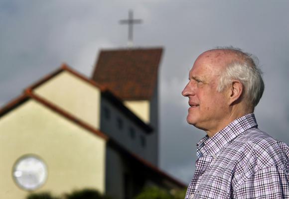 John Boyer in front of St Jude Catholic Church travels in Boca's arts and 