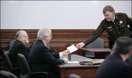 Clark sat with his attorney David Lamberstus