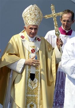 Pope Benedict XVI, flanked by bishop Pietro Marini, Master of Liturgical Celebration walks at the end of a Holy Mass in Ancona' s shipyard, on the shores of the Adriatic Sea, Sunday, Sept. 11, 2011. Pope Benedict XVI prayed for the victims of the Sept. 11 terror attacks and called on world leaders and others to resist what he calls the