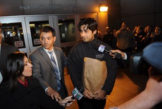The Rev. Uriel Ojeda, at center holding a bag, was released just before 10 p.m. from Sacramento County Main Jail. His attorney, Jesse Ortiz, beside him, worked to free the accused priest on bail.