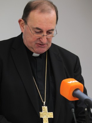 Belgian bishop Guy Harpigny looks down during a media conference in Brussels today