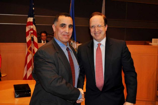 U.S. Immigration and Customs Enforcement Special Agent Rod Khattabi is congratulated by U.S. Attorney David Fein after receiving an award for Exceptional Contributions in Law Enforcement by exposing sex trafficking cases in Fairfield County and sexual abuse committed by U.S. citizens in humanitarian programs in Haiti and South Africa. Photo: Contributed Photo / Connecticut Post Contributed