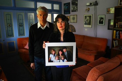 Chrissie Foster and her husband, Anthony, with a portrait of their family, torn apart from church sex crimes. Photo: Craig Sillitoe