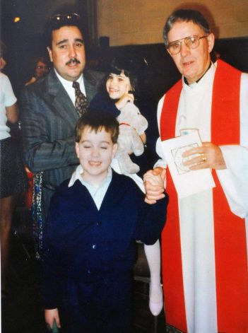 Photo courtesy of the Morales family: Photo of alleged sexual abuse victim Martin Morales at 8-yrs-old with his father Ivan Morales Sr.,and sister Maria with Rev. Jeremiah Nunan, at right. (John Carl D'Annibale / Times Union)