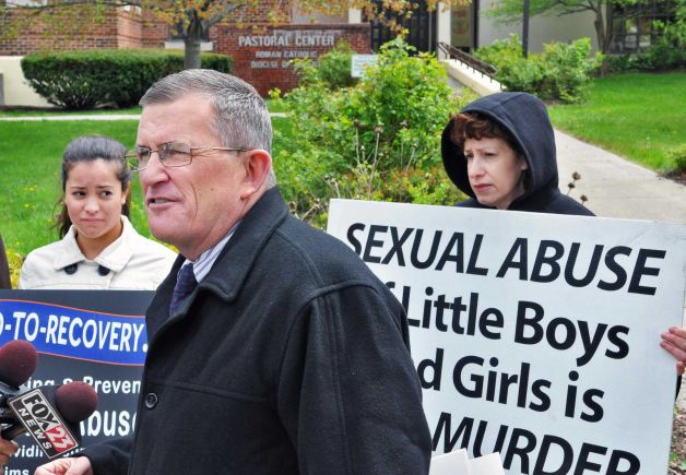 Road to Recovery president Robert Hoatson speaks during a news conference outside the Albany Diocesan headquarters in Albany about alleged sexual abuse victims Martin Morales and his brother Ivan Morales Jr. Tuesday April 24, 2012. At left is the victim's sister Maria Morales and mother Carole Morales, at right. (John Carl D'Annibale / Times Union)