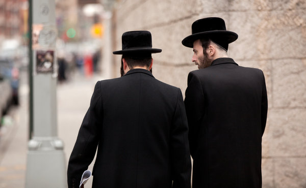 Mordechai Jungreis, right, walks his mentally disabled son, 16, home from school in Brooklyn. More Photos »