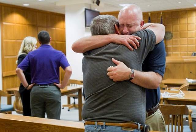 Todd Merryfield hugs his father, Dan, on May 21 after the jury found the Catholic Diocese of Green Bay responsible for concealing Rev. John Feeney's history of child molestation at the Outagamie County Justice Center in Appleton. An attorney for the diocese says the verdict should be overturned. / File/Gannett Wisconsin Media