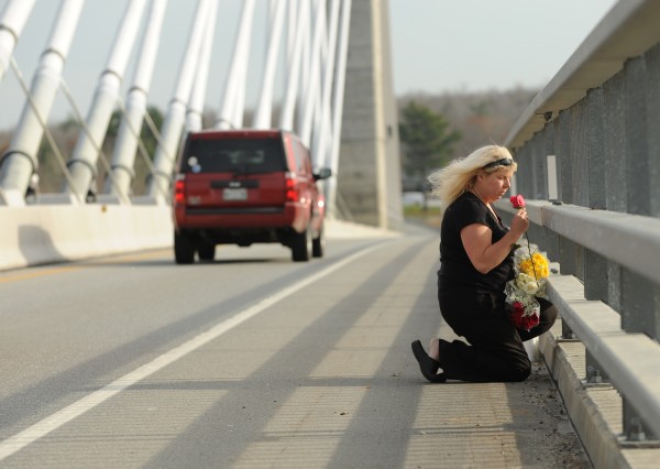 "For you there wil be no crying. For you the sun will be shining," a woman who asked not to be identified said as she tossed flowers off the Penobscot Narrows Bridge on Monday, November 14, 2011. She was honoring the memory of the Rev. Robert Carlson, who jumped from the bridge on Sunday. She explained that Carlson had talked her out of jumping off the same bridge in June 2010. "I was supposed to be in the water." she said. Buy Photo
