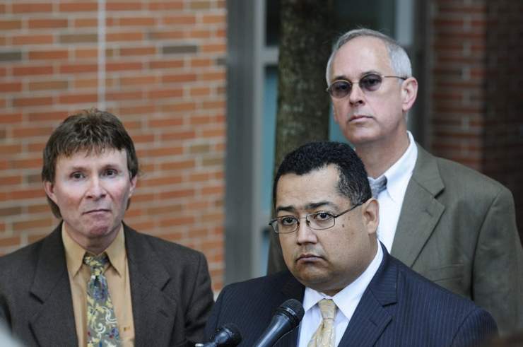 Alain J. Beret, left, and James Fairbanks, right, appear at a press conference this morning, along with one of their lawyers, Sergio E. Carvajal of the Worcester law firm Carvajal & Nielson. (T&G Staff/DAN GOULD)