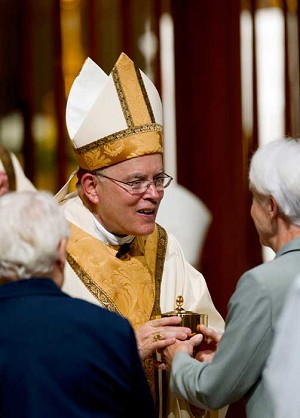 Archbishop Charles Chaput accepts the gifts during his installation Mass at the Cathedral Basilica of Sts. Peter and Paul in Philadelphia.