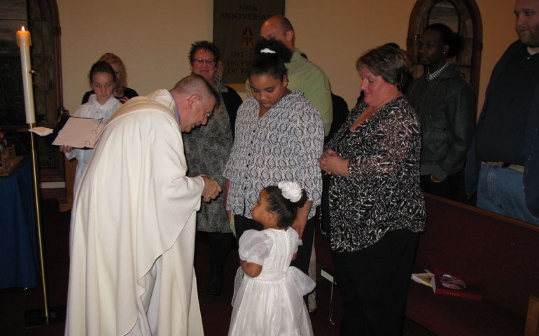 Fr. David Verhasselt baptizes Ayanna Frances Smith Nov. 24 at Holy Name of Jesus in Ashippun, Wis.