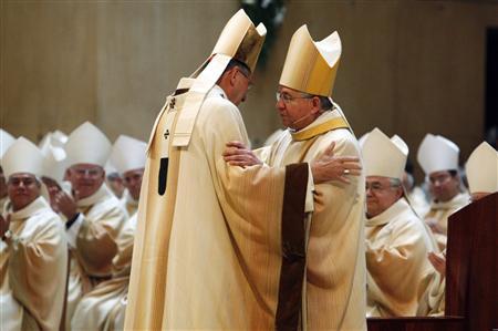 Cardinal Roger Mahony (L) greets Archbishop Jose Gomez during the welcoming Mass marking the start of Coadjutor Archbishop Gomez's ministry in Los Angeles in this May 26, 2010 file photo.