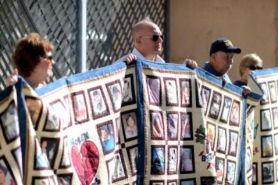 Church sex-abuse victim Jorgen Olsen holds part of a "survivors quilt" outside the Cathedral of Our Lady of the Angels in downtown Los Angeles during a SNAP press conference on Feb. 1, 2013, regarding the previous day's release of church abuse files. (Andy Holzman/Los Angeles Daily News)