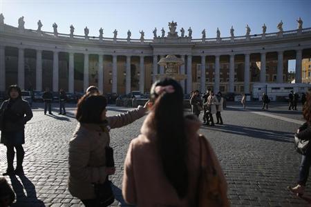 Tourists visit Saint Peter's square at the Vatican February 14, 2013.