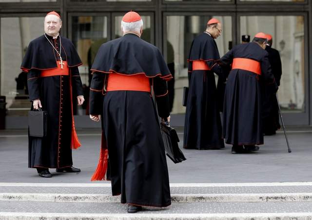 Cardinal Gianfranco Ravasi, left, joins other cardinals as he arrives for a meeting at the Vatican, Friday, March 8, 2013. (Alessandra Tarantino / Associated Press)