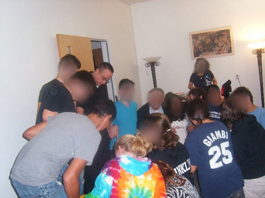 The Rev. Michael Fugee participates in a prayer circle with teens and adults during a pilgrimage to Canada in 2010. It was trips like these led to his being charged with violating a court order.
