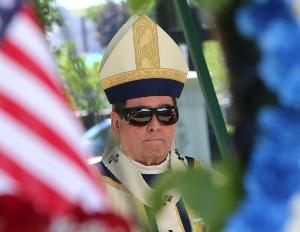 Archbishop John J. Myers on the altar during a Memorial Day at Holy Cross Cemetery in North Arlington on Monday.