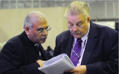 At the 2012 United Nations Conference on Sustainable Development held in Rio de Janeiro, Holy See Permanent Observer Archbishop Francis Chullikatt (left) consults with Paul Kelly, the delegate from Nicaragua, on Section V of the Rio+20 draft text, which included language on reproductive health.