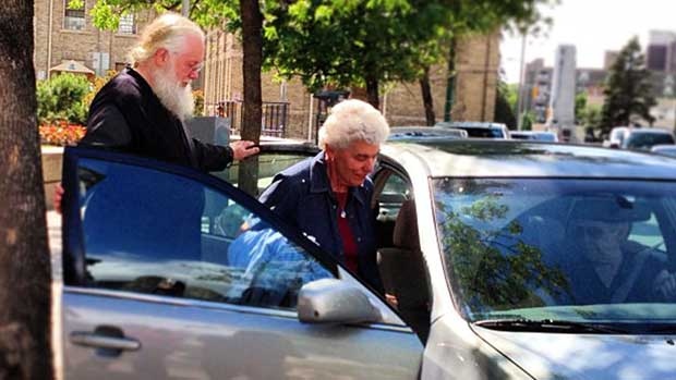 Archbishop Kenneth (Seraphim) Storheim, left, and a supporter leave the Winnipeg courthouse in June. (Karen Pauls/CBC)