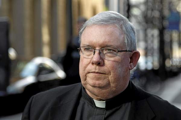 FILE - In this March 27, 2012 file photo, Monsignor William Lynn leaves the Criminal Justice Center in Philadelphia. A Pennsylvania appeals court on Tuesday Sept. 17, 2013 heard defense arguments that that Lynn was wrongly convicted for his handling of priest sex-abuse complaints. Lynn is serving three to six years in prison after his 2012 felony child-endangerment conviction. (AP Photo/Alex Brandon, File)