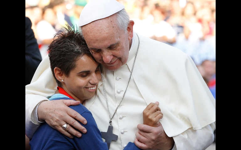 Pope Francis embraces a young woman during an encounter with youth in Cagliari, Sardinia, Sept. 22. (CNS/Paul Haring)