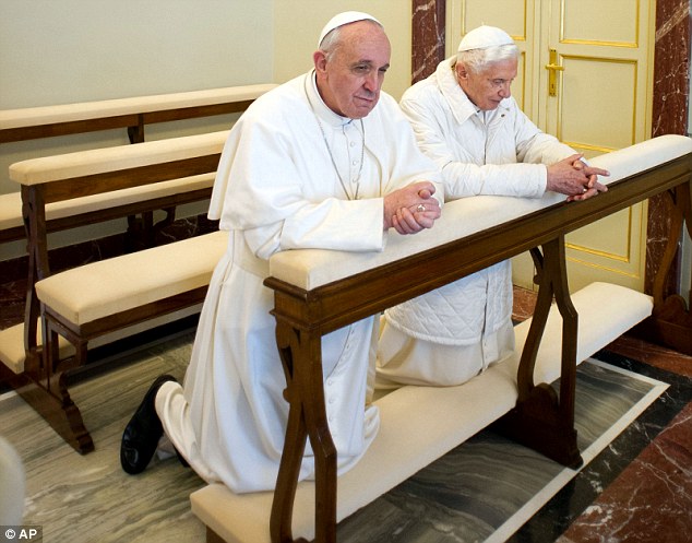 In and out: Pope Francis (left) and Pope Emeritus Benedict XVI pray together in Castel Gandolfo, Italy, in March