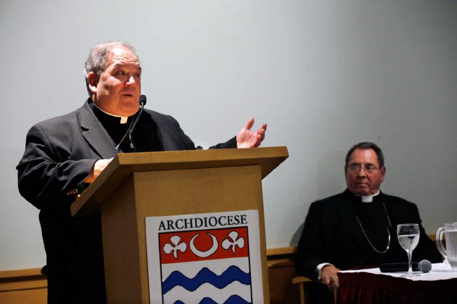 Archbishop John Myers, right, listens to Bishop Bernard Hebda, currently of Gaylord, Michigan, in Newark, N.J., Tuesday, Sept. 24, 2013, after it was announced that the pope has named Hebda coadjutor bishop to help out and eventually take over for the archbishop of Newark when Myers retires in mid-2016. (AP Photo/Mel Evans)