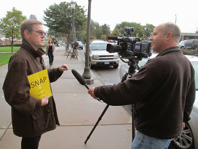 Above: David Clohessy (left), National Director of the Survivors Network of those Abused by Priests (SNAP), being interviewed by a reporter from the Star Tribune.