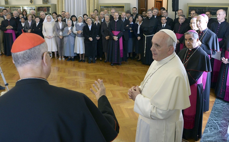 Pope Francis listens as the outgoing Vatican secretary of state, Cardinal Tarcisio Bertone, gives a speech during the cardinal's farewell ceremony Tuesday at the Vatican. (CNS/Reuters/L'Osservatore Romano)