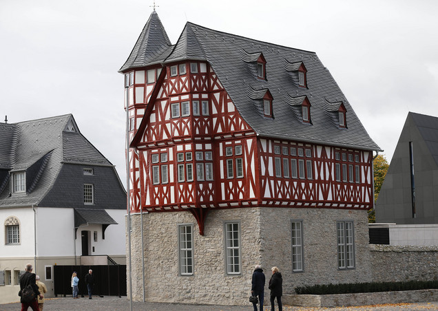 People watch the residence of Franz-Peter Tebartz-van Elst, Bishop of Limburg, in Limburg, Germany, Thursday, Oct. 17, 2013. Bishop Tebartz-van Elst, currently at the Vatican to meet pope Francis, is accused of wasting money to refurbish and rebuild the residence for more than 31 million euro ( 42 million dollar). (AP Photo/Frank Augstein)