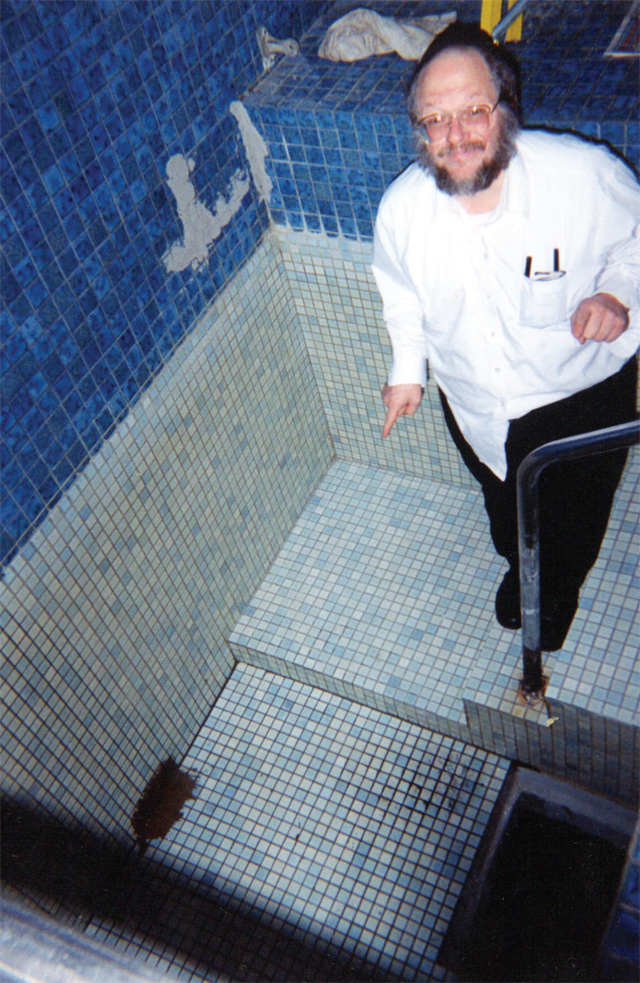 Rabbi Rosenberg inspects a ritual purification bath, known as a mikvah. In 2005, he witnessed a young boy being raped inside a similar bath.