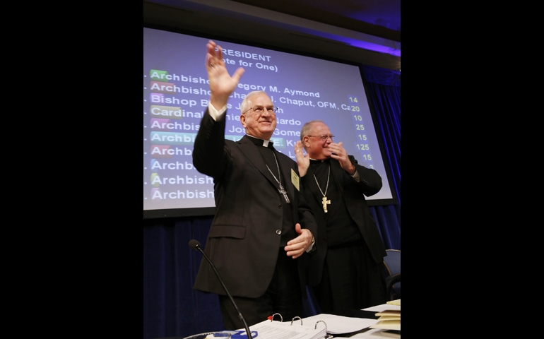 Archbishop Joseph Kurtz of Louisville, Ky., is elected the new president of the U.S. Conference of Catholic Bishops on Tuesday in Baltimore, succeeding New York Cardinal Timothy Dolan, right. (CNS/Nancy Phelan Wiechec)