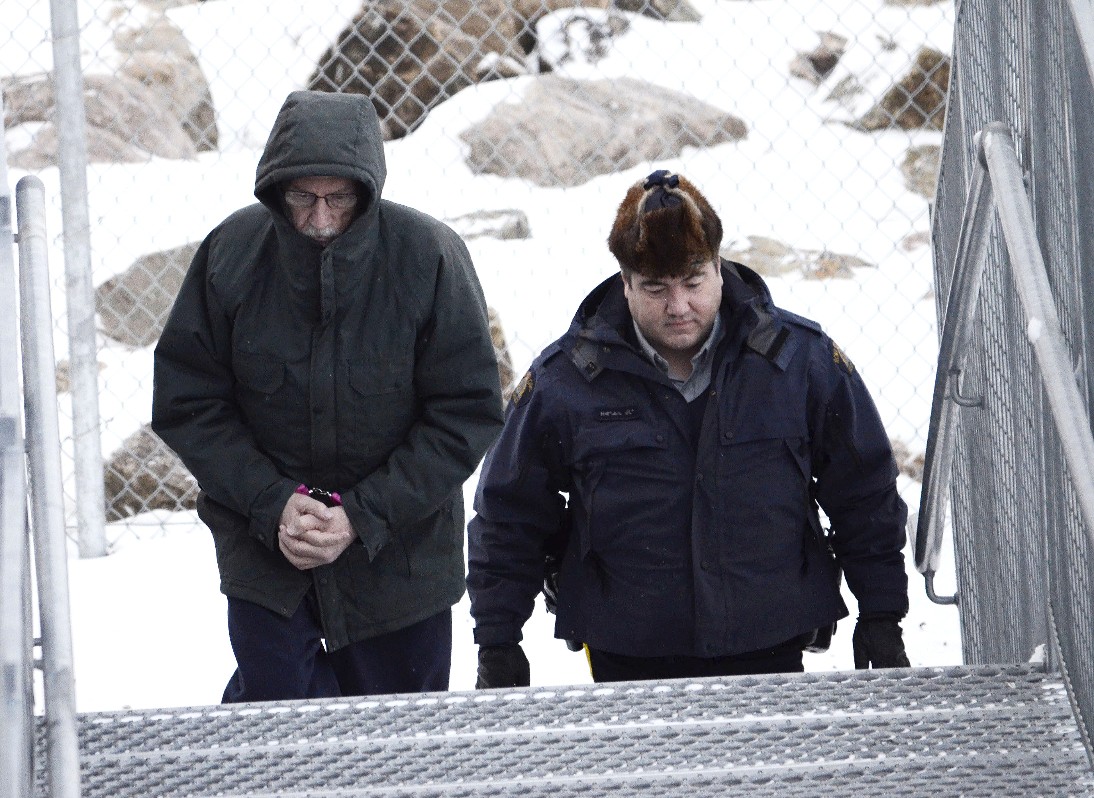 Eric Dejaeger is escorted to the Nunavut Court of Justice in this file photo. A woman testified Nov. 29 that there was a lot of distrust of priests after Dejaeger left Igloolik 30 years ago but people still go to church there today. (FILE PHOTO)