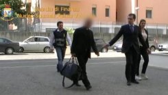 This handout picture taken from a video released by the Guardia di Finanzia Italian police on June 28, 2013 shows Nunzio Scarano (2nd left) being escorted by policemen after being arrested the same day in RomeThis handout picture taken from a video released by the Guardia di Finanzia Italian police on June 28, 2013 shows Nunzio Scarano (2nd left) being escorted by policemen after being arrested the same day in Rome