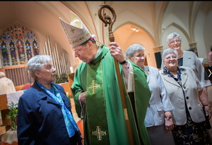 Sister Peggy Sullivan, left, talks with Deeley in October at St. Agatha’s Church in Milton, Mass.