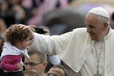 Pope Francis blesses a child during the weekly general audience in St. Peter's Square at the Vatican in October.
