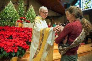 Monsignor Ed Ciuba greeting parishioners at Christmas Mass at the Church of the Presentation in Upper Saddle River. Many North Jersey Catholics are encouraged by Pope Francis’ non-judgmental tone.
