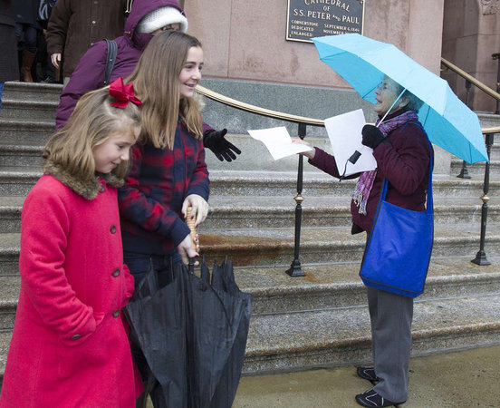 Judy Miller hands out leaflets at the Cathedral Basilica of SS. Peter and Paul. She and her husband are upset by the ruling that reversed Msgr. William J. Lynn's child-endangerment conviction. (ED HILLE / Staff Photographer)
