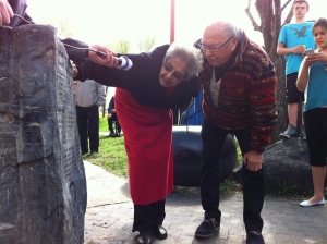 Ann Callahan and Ted Fontaine read the residential schools monument at the Canadian Museum for Human Rights in Winnipeg on Monday. (Meagan Fiddler/CBC)