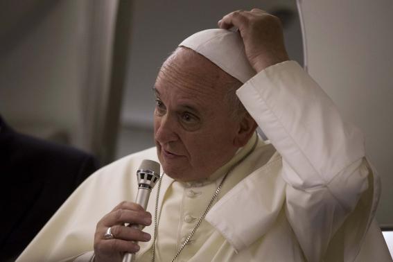 1 OF 2. Pope Francis talks to reporters aboard the papal flight on his way back to the Vatican from Jerusalem May 26, 2014.