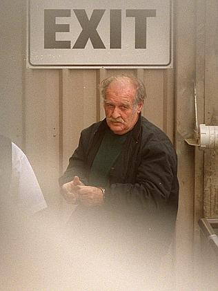 Brian Perkins is extradited back to SA in police custody. Picture: Michael Milnes