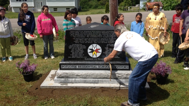 A monument engraved with 24 names of residential school survivors was unveiled at Potlotek school. (Hal Higgins/CBC)