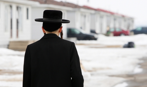 A member of the Lev Tahor ultra-orthodox Jewish sect walks home from taking his son to school in Chatham, Ont., Monday, March 10, 2014.