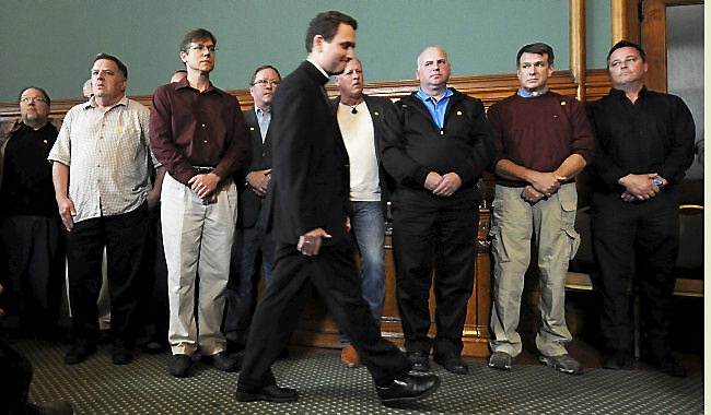 Andrew Cozzens, auxiliary bishop of the Archdiocese of St. Paul and Minneapolis, walks past a line of clergy sex abuse victims during a news conference in St. Paul on Monday, Oct. 13, 2014. (Pioneer Press: Scott Takushi)
