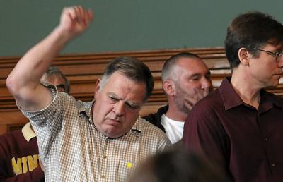 Tom Mahowald of St. Paul, who was sexually abused as an 11-year-old at Guardian Angels Church in Hastings in 1961, pumps his fist in reaction to a new child protection plan announced jointly by Jeff Anderson & Associates and the Archdiocese of St. Paul and Minneapolis during a news conference in St. Paul on Monday, Oct. 13, 2014. (Pioneer Press: Scott Takushi)