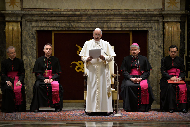 Pope Francis delivers his message during a meeting with cardinals and bishops of the Curia at the Vatican on Monday. The pope said the Curia suffered from "spiritual Alzheimer's" and careerism.