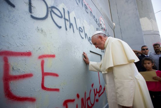 Pope Francis prays for peace in front of the Israeli security wall in Bethlehem, West Bank, May 25. CNS photo/L’Osservatore Romano, pool