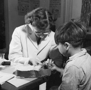 A nurse takes a blood sample from a boy in Port Alberni, British Columbia, during a Department of National Health and Welfare survey. (Library and Archives of Canada)