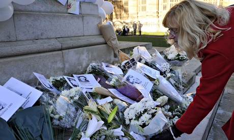 A woman leaves a floral tribute during an event organised in commemoration of victims and survivors of child abuse. Photograph: Nick Ansell/PA