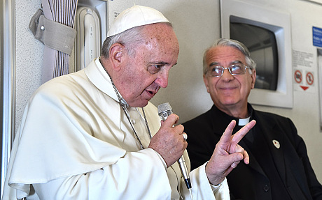 Pope Francis gestures as he talks with journalists during his flight from Manila to Rome